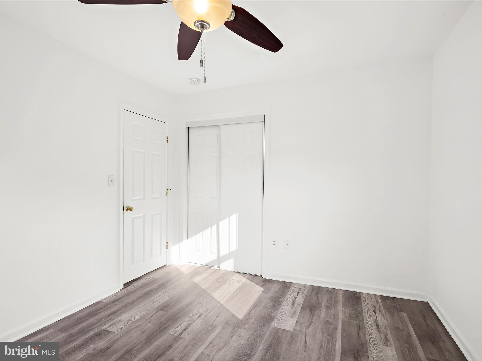 400 Dale Avenue Baltimore, MD 21206 - Photo 13 of 27 an empty room with wooden floor closet and windows