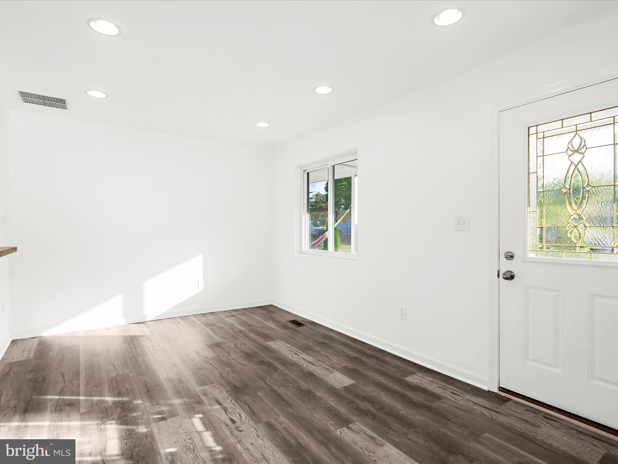 400 Dale Avenue Baltimore, MD 21206 - Photo 5 of 27 an empty room with wooden floor and windows