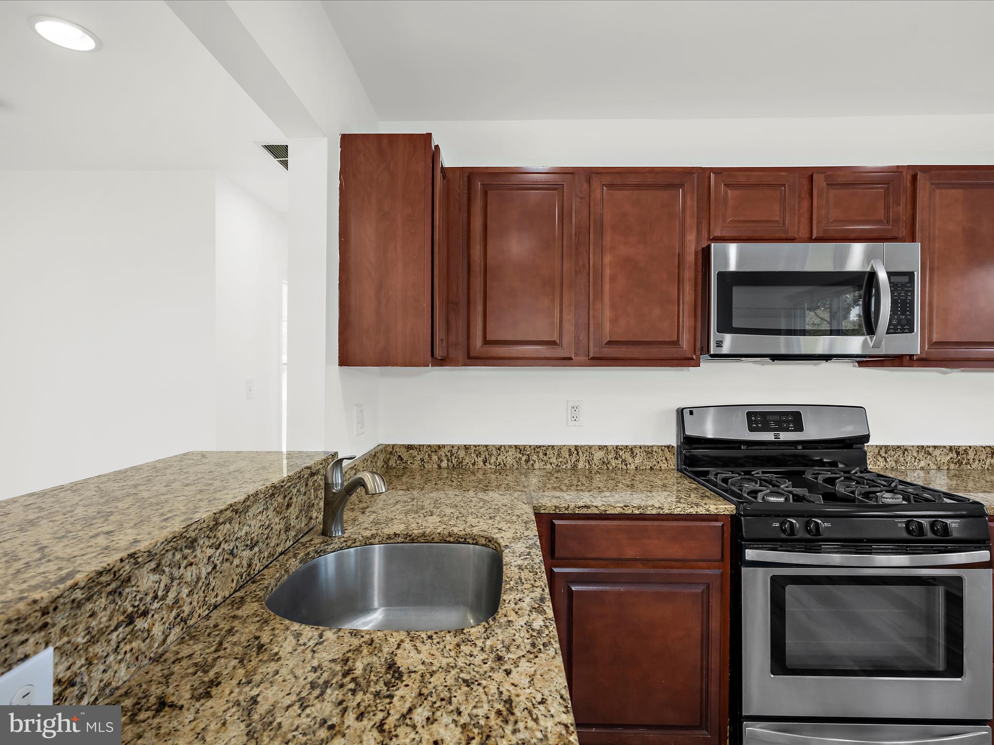 400 Dale Avenue Baltimore, MD 21206 - Photo 9 of 27 a kitchen with granite countertop a sink and steel appliances