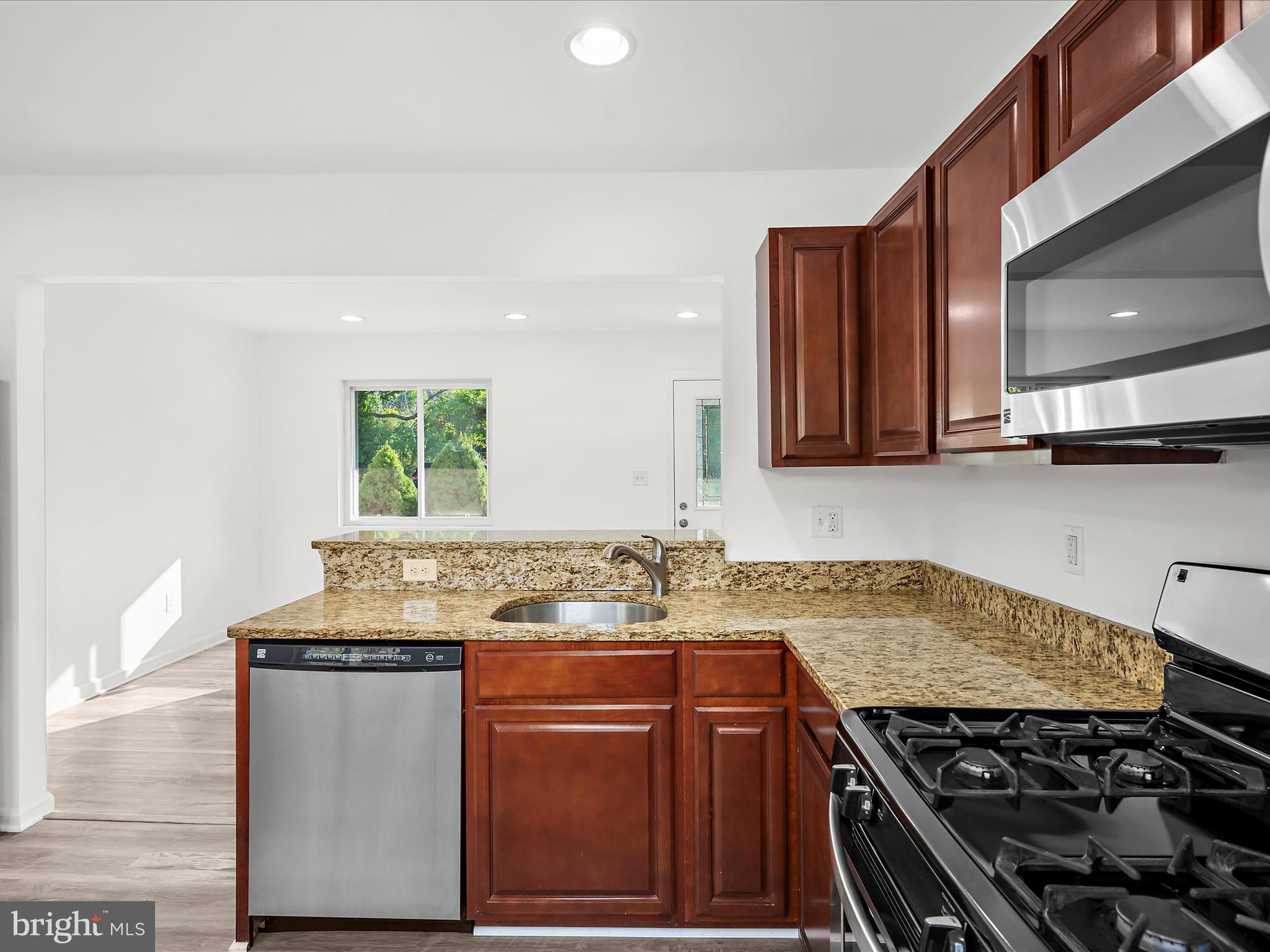 400 Dale Avenue Baltimore, MD 21206 - Photo 10 of 27 a kitchen with stainless steel appliances granite countertop a sink stove and cabinets