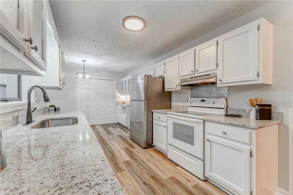 10 Thornwood Drive Southwest Rome, GA 30165 - Photo 17 of 57 a kitchen with white cabinets and stainless steel appliances