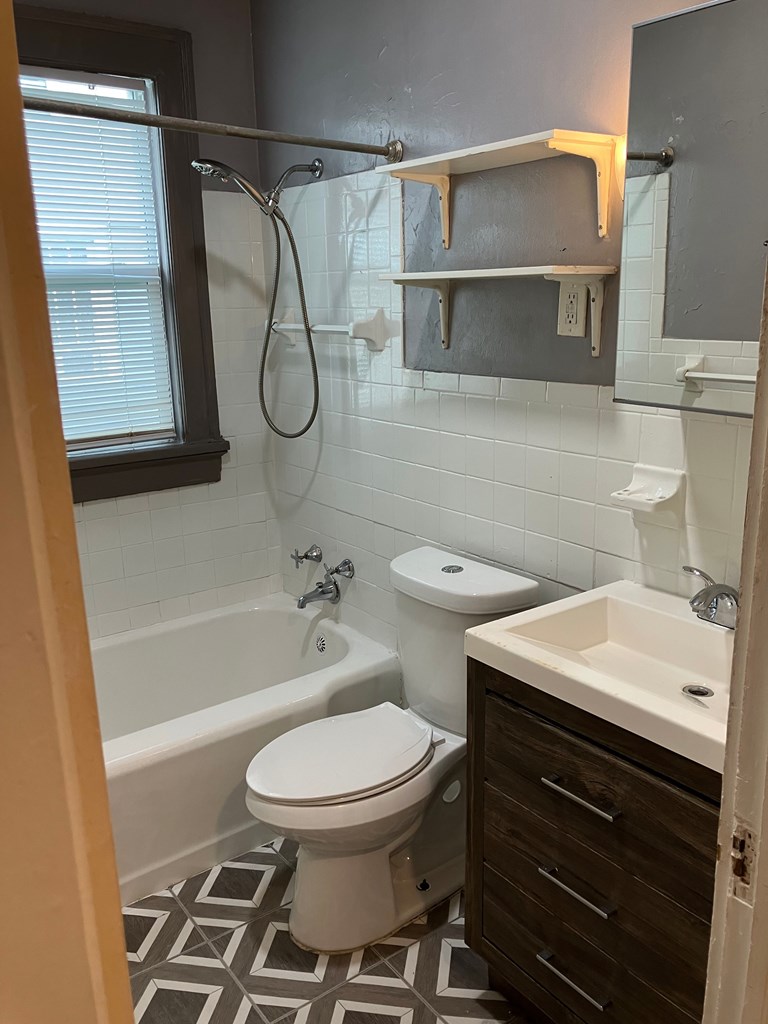2318 Huggins Street Columbus, GA 31903 - Photo 13 of 40 a bathroom with a toilet a sink and a shower