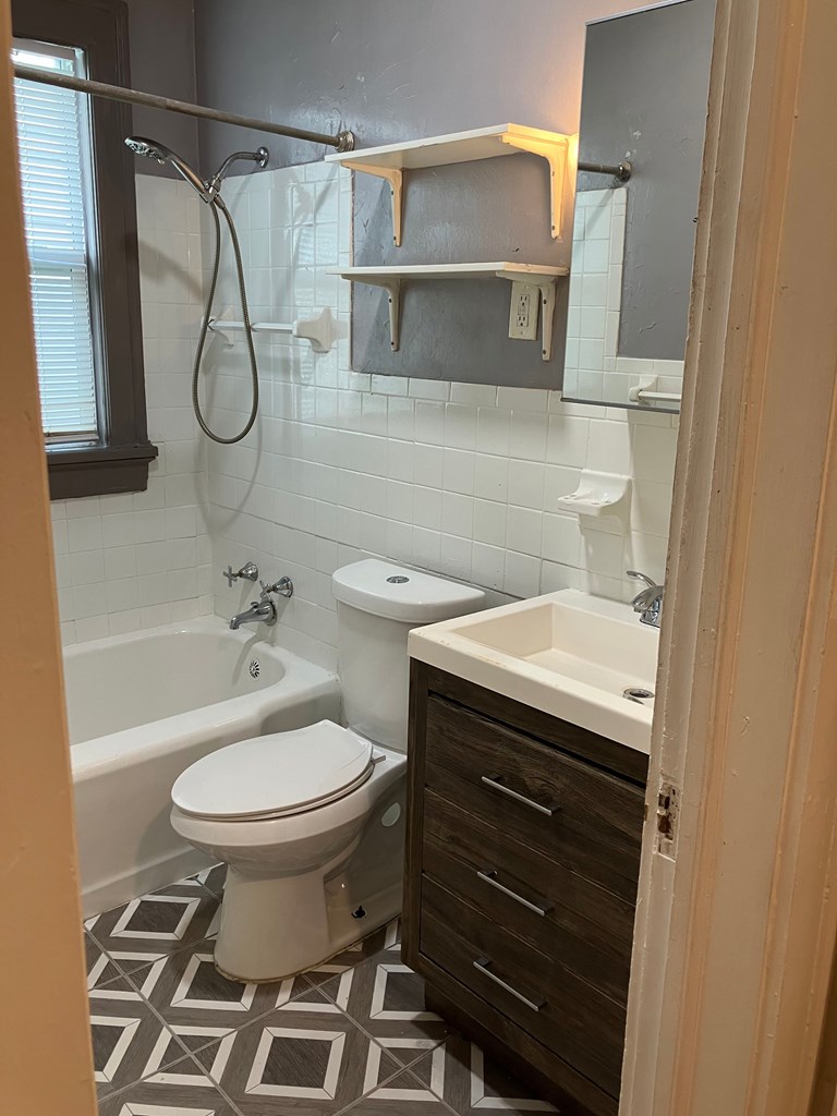 2318 Huggins Street Columbus, GA 31903 - Photo 15 of 40 a bathroom with a granite countertop sink toilet and a mirror