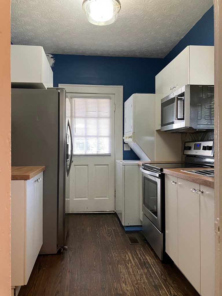 2318 Huggins Street Columbus, GA 31903 - Photo 20 of 40 a kitchen with stainless steel appliances a sink a stove a refrigerator and cabinets