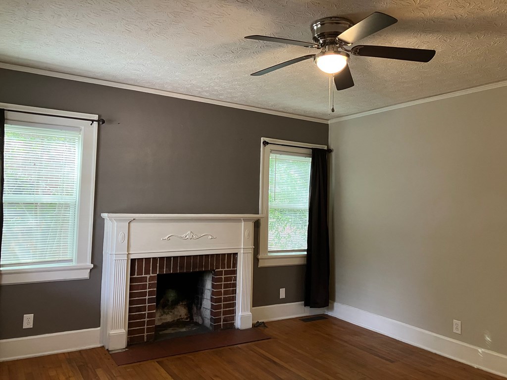 2318 Huggins Street Columbus, GA 31903 - Photo 2 of 40 a living room with a fireplace and a ceiling fan