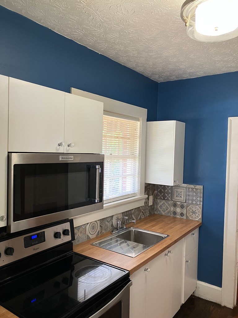 2318 Huggins Street Columbus, GA 31903 - Photo 29 of 40 a kitchen with a sink stove and microwave