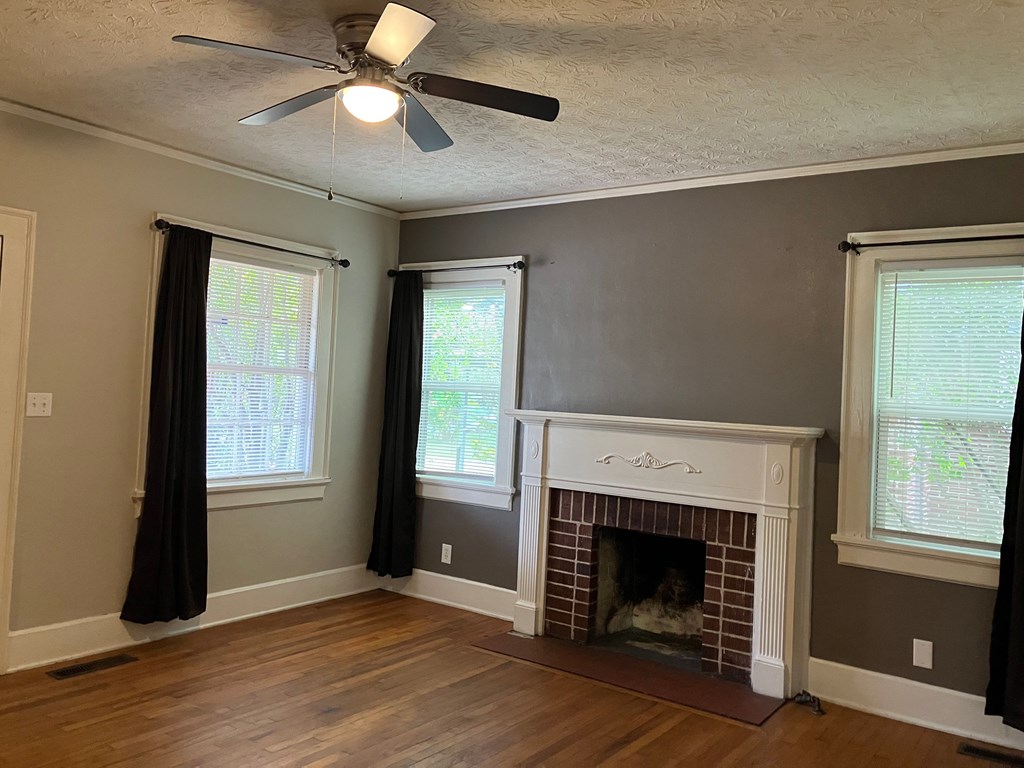 2318 Huggins Street Columbus, GA 31903 - Photo 3 of 40 a view of an empty room with window and fire place