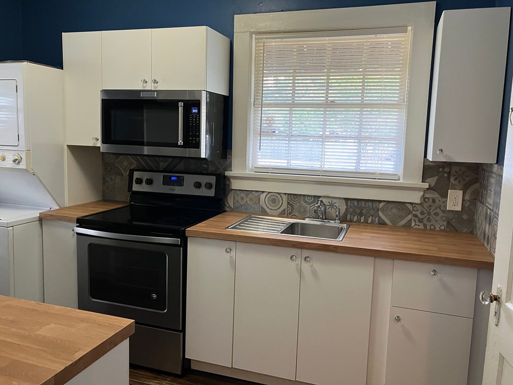 2318 Huggins Street Columbus, GA 31903 - Photo 32 of 40 a kitchen with a sink stove and microwave