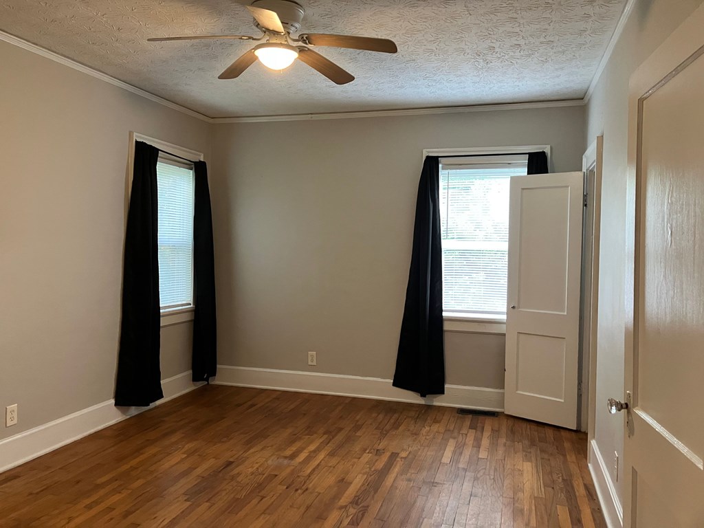 2318 Huggins Street Columbus, GA 31903 - Photo 4 of 40 an empty room with wooden floor closet and windows