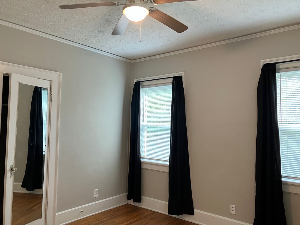 2318 Huggins Street Columbus, GA 31903 - Photo 9 of 40 a view of an empty room with wooden floor and a window