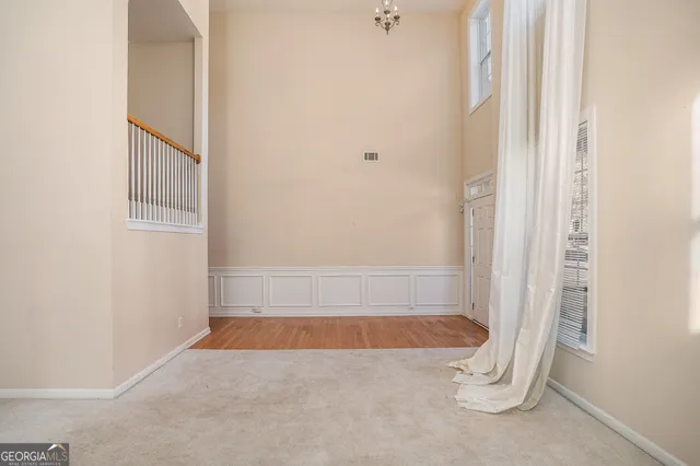 an empty room with a empty space and windows