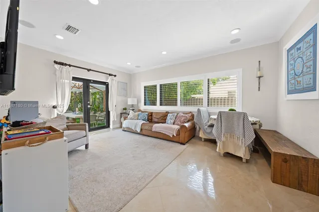a bedroom with furniture and a large window