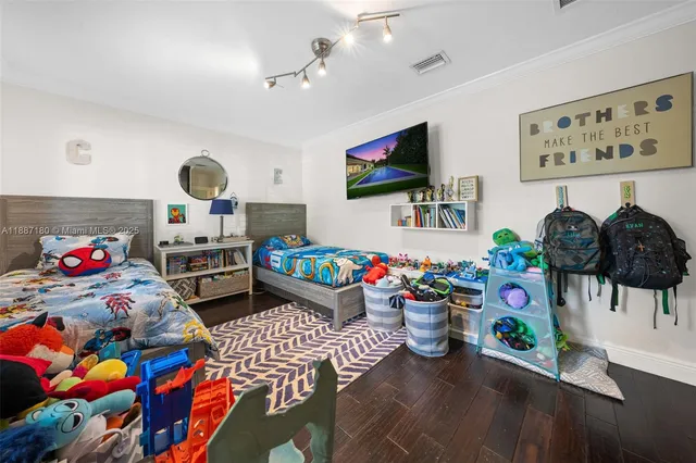 a living room filled with a flat screen tv and a couch