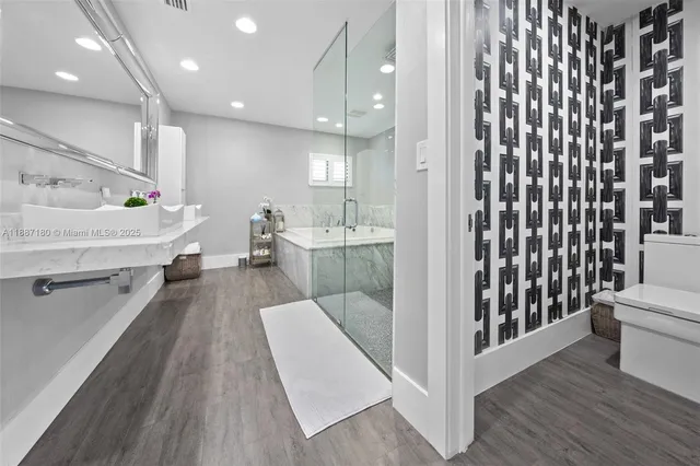 a view of a living room with furniture and wooden floor