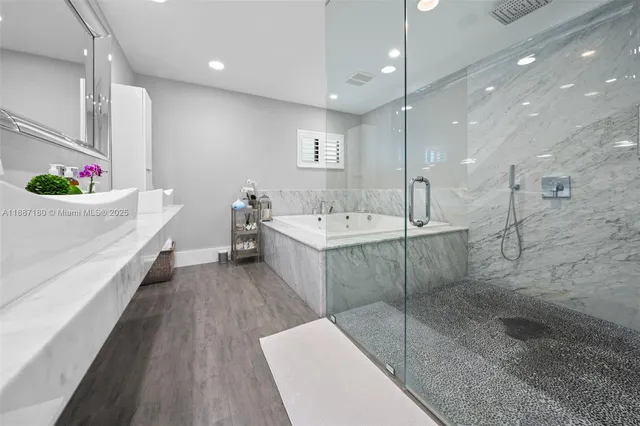 a bathroom with a double vanity sink mirror and shower