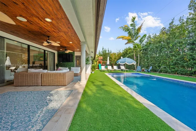 a view of a house with a backyard patio and sitting area