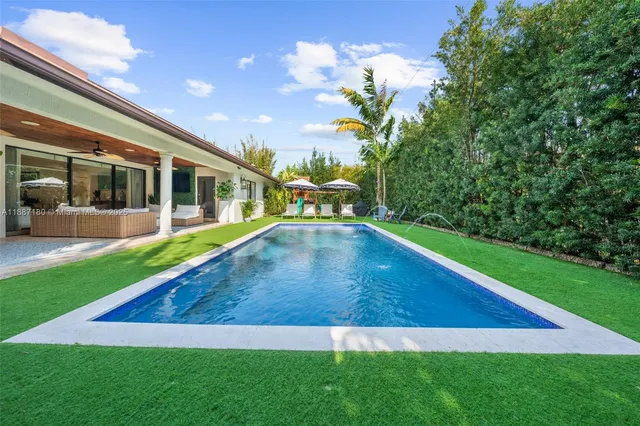 swimming pool view with a garden space