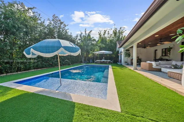 an aerial view of a house with a yard