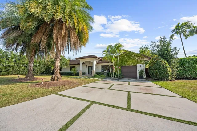 a front view of house with yard and green space