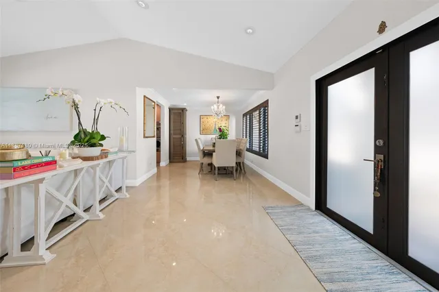 a view of a bedroom with wooden floor & windows