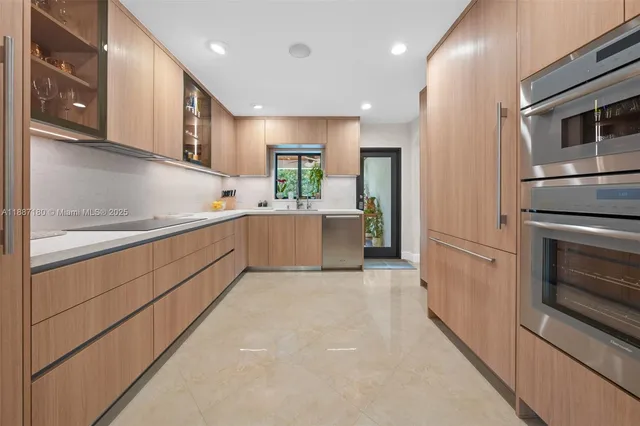 a kitchen with stainless steel appliances granite countertop a refrigerator and a sink
