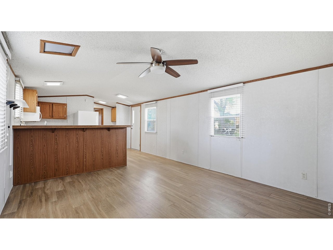 256 Navajo Road Weldona, CO 80653 - Photo 7 of 27 a room with wooden floor and ceiling fan