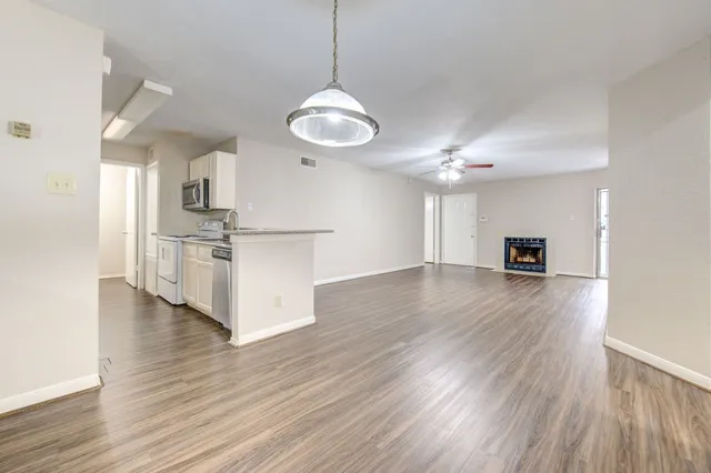a view of a kitchen with stove and wooden floor