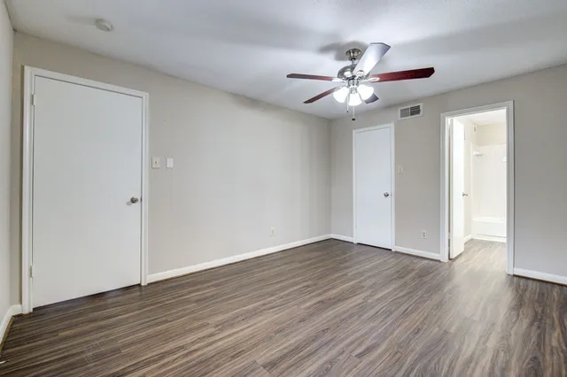 a view of an empty room with wooden floor