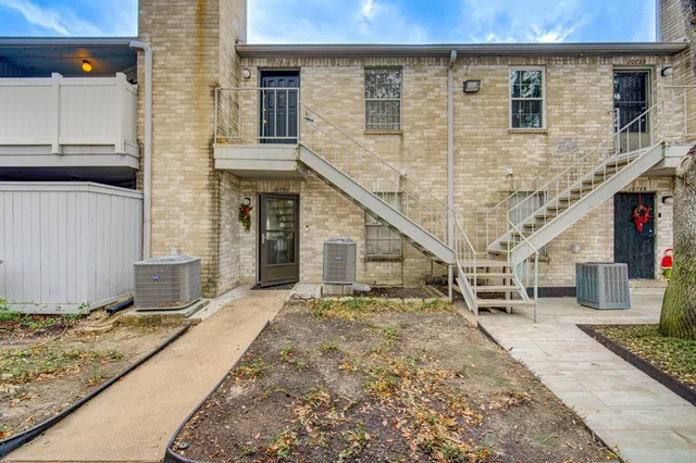 a view of a stone house with large windows