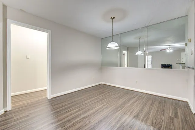 a view of a room with wooden floor
