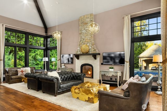 a living room with furniture a fireplace and a large window
