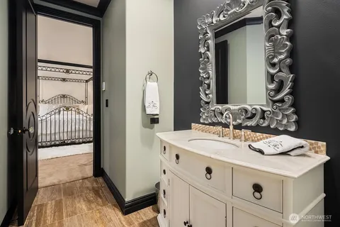 a en suite bathroom with a sink mirror and vanity