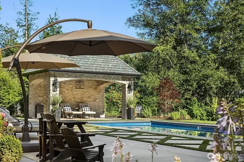 a view of a chairs and table under an umbrella in patio