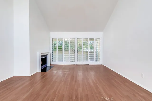 a view of an empty room and a fireplace