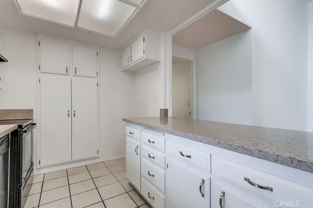 a kitchen with a granite countertop sink and a window