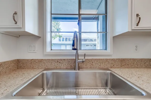 a kitchen with granite countertop a sink and a stove