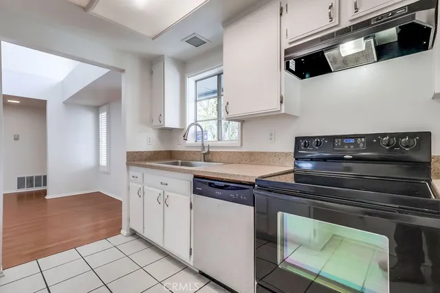 a kitchen with stainless steel appliances granite countertop a stove and a sink
