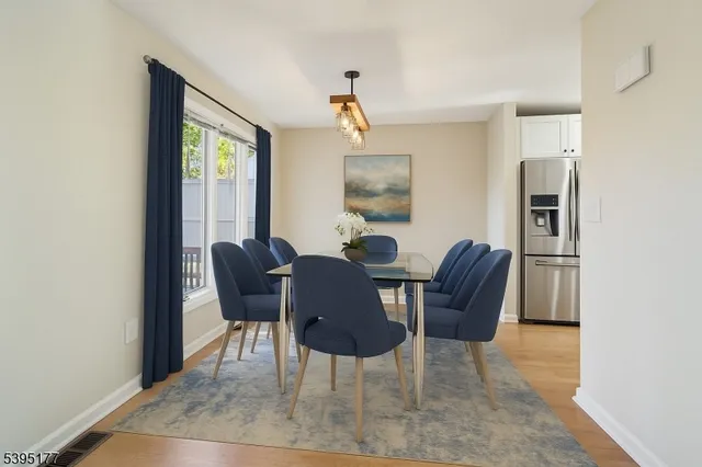 a view of a dining room with furniture and window