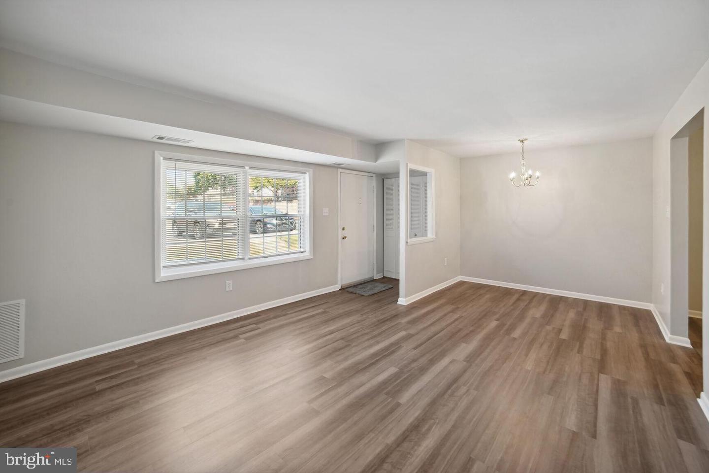 9655 Homestead Court, Unit B Laurel, MD 20723 - Photo 2 of 10 a view of an empty room with wooden floor and a window