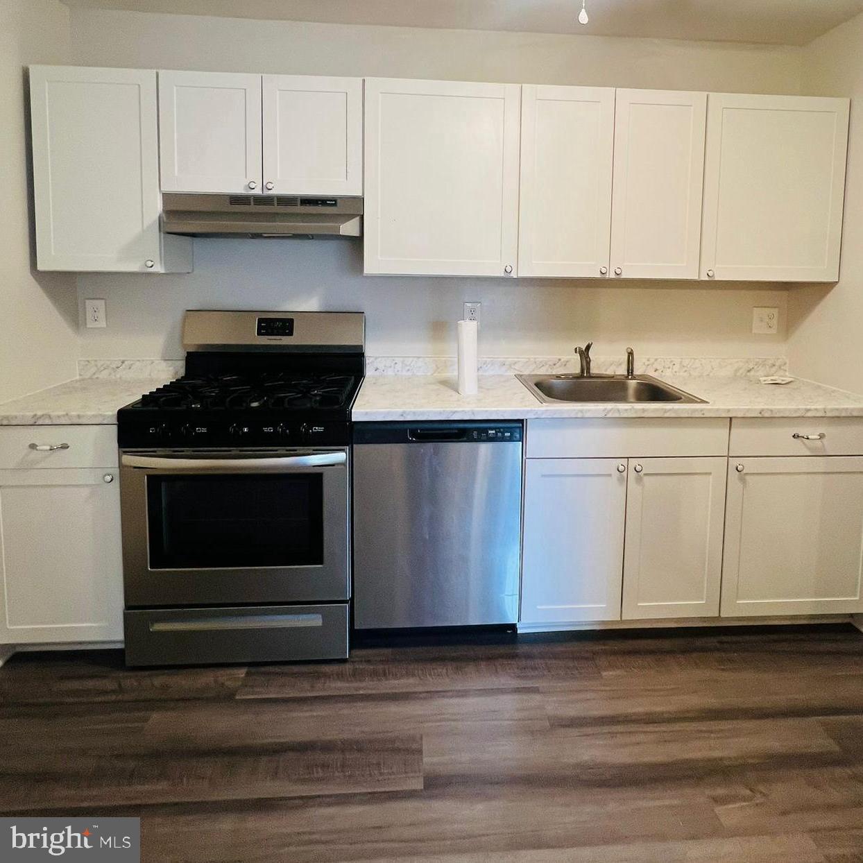 9655 Homestead Court, Unit B Laurel, MD 20723 - Photo 5 of 10 a kitchen with granite countertop white cabinets and stainless steel appliances