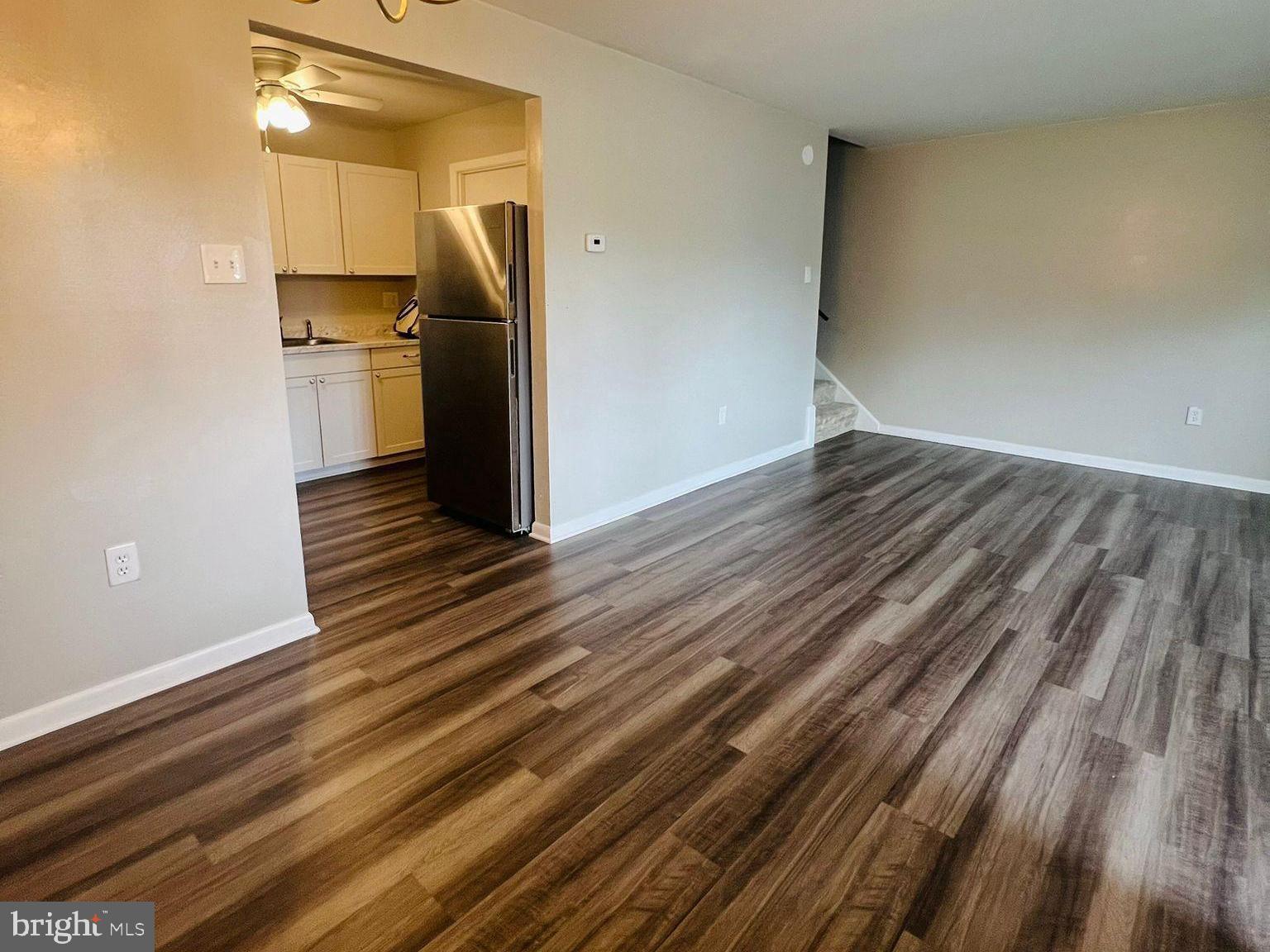 9655 Homestead Court, Unit B Laurel, MD 20723 - Photo 7 of 10 a view of a refrigerator in kitchen and an empty room