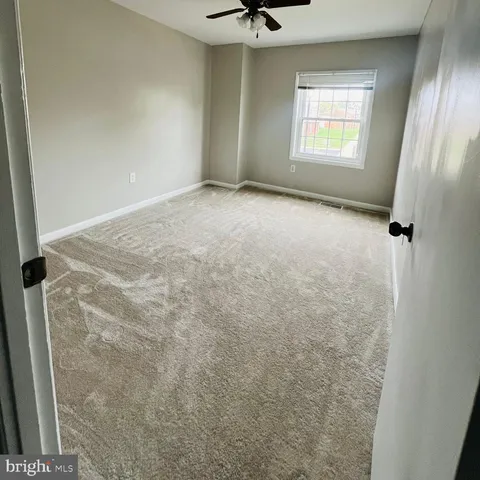 a view of an empty room and a window