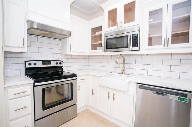 a kitchen with stainless steel appliances a stove and a microwave