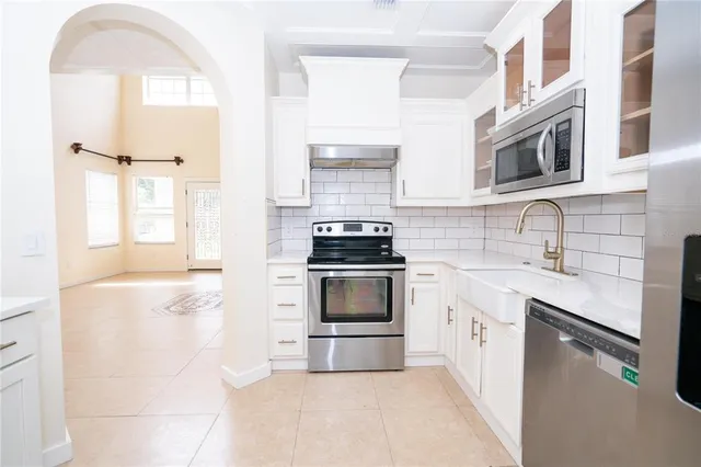 a kitchen with stainless steel appliances a stove sink and cabinets