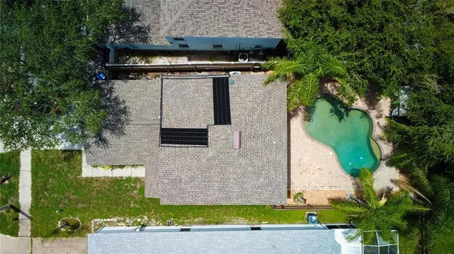 an aerial view of a house with a yard
