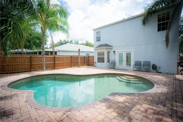 a view of a house with a swimming pool and porch