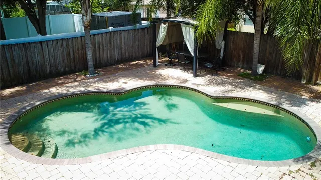 a view of a backyard with swimming pool