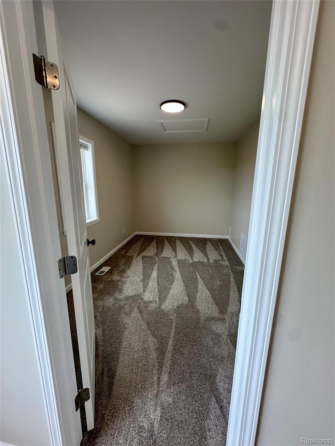 2670 Riley Center Road Memphis, MI 48041 - Photo 17 of 39 Empty room with attic access and light colored carpet