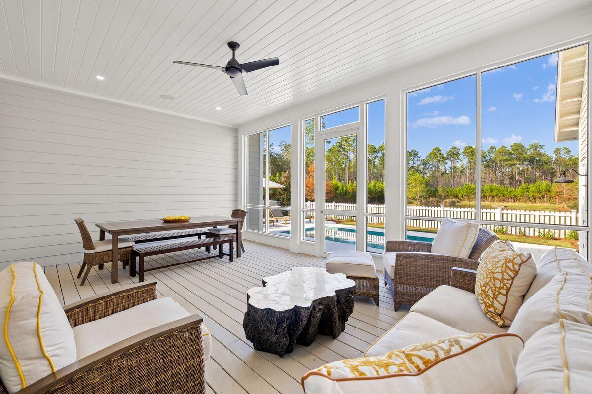 41 Seastone Ct Inlet Beach Inlet Beach, FL 32461 - Photo 27 of 52 a living room with furniture and a floor to ceiling window