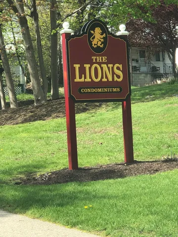 a sign broad in front of the tree
